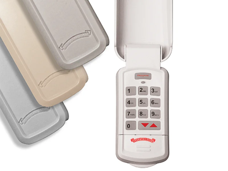 Digital wireless keypad with multiple color options, featuring programming buttons for garage door openers, emphasizing compatibility with Overhead Door™ systems.