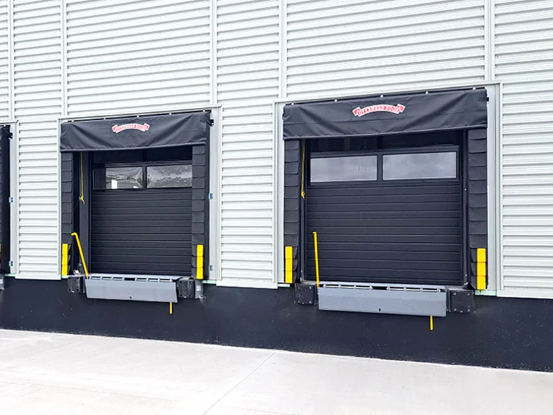 Dock levelers and adjustable curtain seals at a commercial loading dock, showcasing efficient and durable dock equipment solutions from Overhead Door Company of The Desert™ in Thousand Palms, CA.