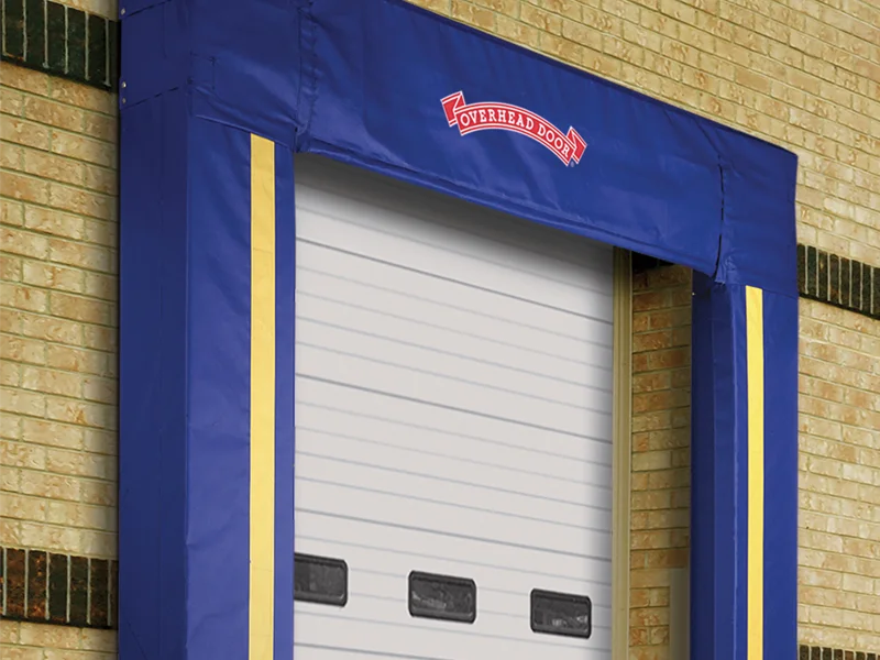 Foam dock shelter with adjustable curtains and impact-resistant columns, featuring Overhead Door branding, designed for weather protection and insulation in loading dock environments.