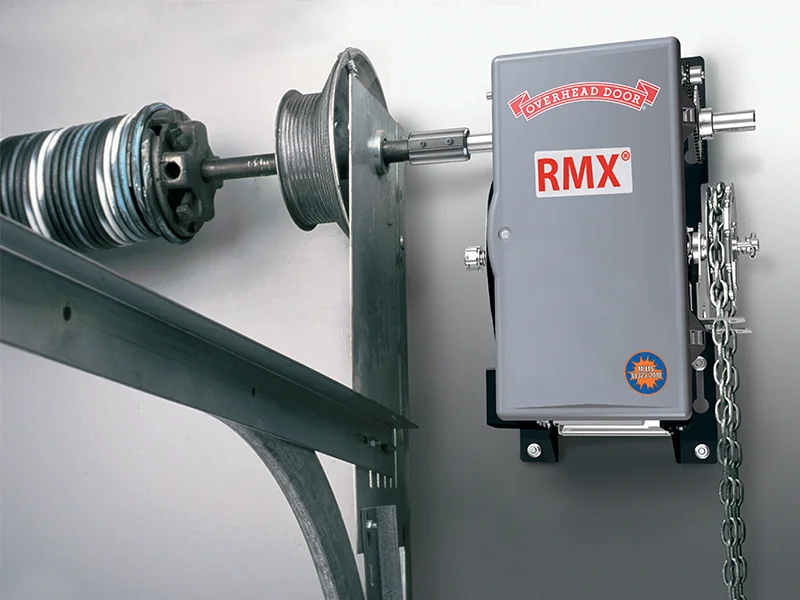 Commercial garage door operator RMX® by Overhead Door Company, featuring chain mechanism and steel components, designed for reliability and integration with commercial door systems.