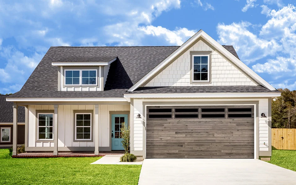 Modern home exterior featuring a white facade, a stylish Beachwood plank garage door, and a light blue front door, set against a bright blue sky.