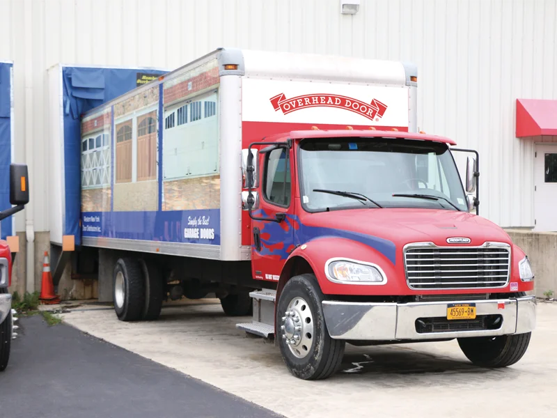 Truck with Overhead Door branding, showcasing cargo area and loading dock, emphasizing commercial vehicle solutions for efficient transport and delivery.